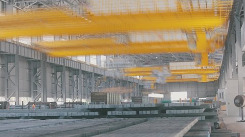 The work of an overhead crane at the time laps plant. Working process at a metal production factory. The work of the crane at the time laps plant. An overhead crane in a modern factory.