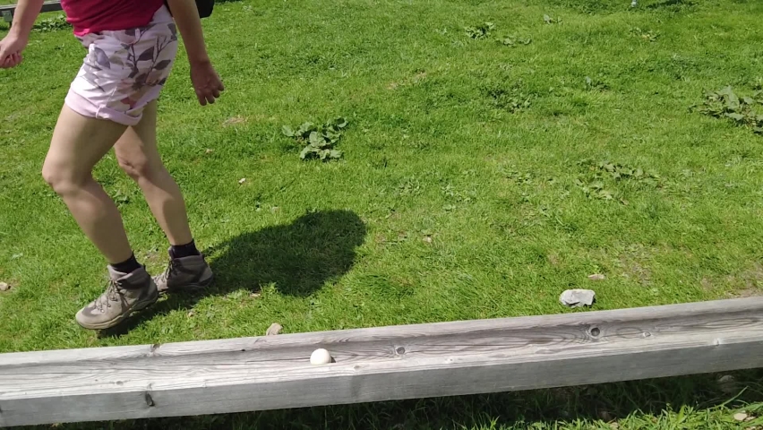 Tourist woman playing marble run murmelibahn. In Parpaner Rothorn mount of Switzerland. Albula region in Grisons canton. SLOW MOTION