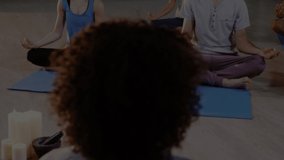 Animation of glowing light over people practicing yoga. fitness and healthy lifestyle concept digitally generated video.
