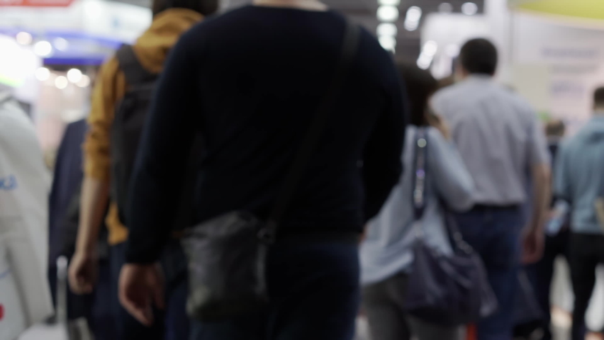 Blurred video of people wearing medical masks.