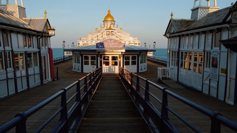 EASTBOURNE, circa 2021 - Walking along Eastbourne Pier in Eastbourne, East Sussex, England, a fashionable tourist seaside resort, east of Beachy Head