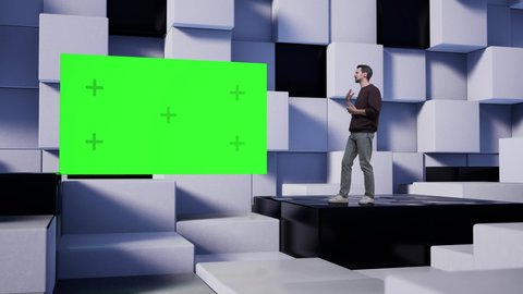 Caucasian man in jeans TV presenter in the news studio with white and black cubes. A green screen with markers flies onto the stage.