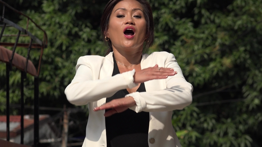 An Asian Woman Talking Emphatically