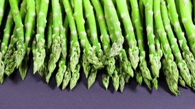 Asparagus, Fresh raw organic green Asparagus sprouts closeup, Healthy vegetarian food. Raw vegetables, market. Vegan backdrop. Slow motion 4K UHD video
