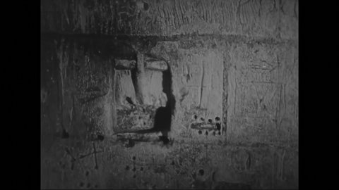 1940s: Dungeon door closes. Stone cell with barred window. Cross carving in cell wall.