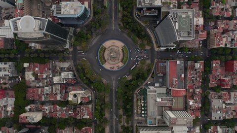 Aerial birds eye overhead top down view of traffic in wide city street. Multilane roundabout crossroad from height. Mexico City, Mexico.