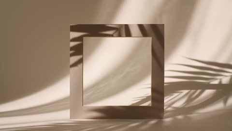 Geometry Frame for Show Product Display on Pastel Beige Background in the Morning Rays of Light and Palm Leaves Shadows. Abstract Minimal Mock up Scene for Product Presentation. Stage Pedestal