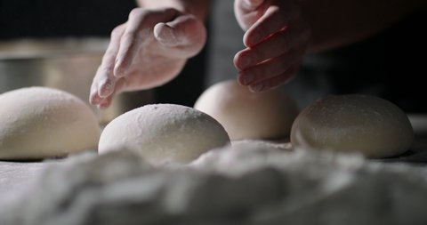 Close up shot of bakery worker carefuly forming loafs of bread. Baker making dough, using natural ingredients. food and drink 4k footage