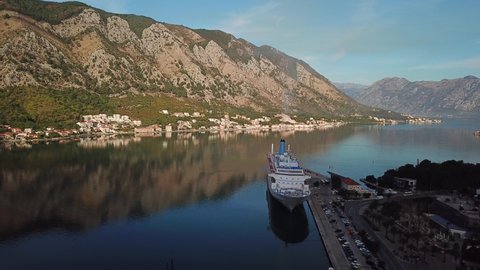 Kotor, Montenegro - September 2019: Aerial view of a large Tui international luxury cruise liner ship docked in the Adriatic Sea marina of Kotor Boko Bay Montenegro against the mountains