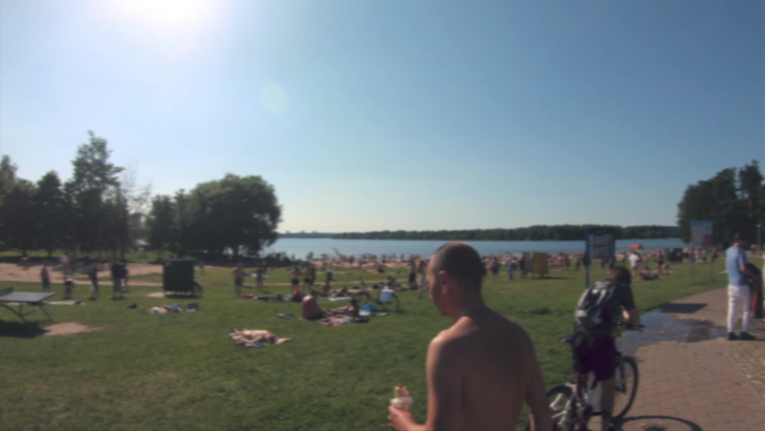 People on the beach. Hot summer day. Camera blur effect. Slow motion.