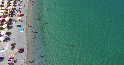 Aerial view of the beach of Katerini in Greece. colorful umbrellas and people who swims. Aerial shot