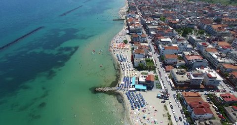 Aerial view of the beach of Katerini in Greece. colorful umbrellas and people who swims. Aerial shot