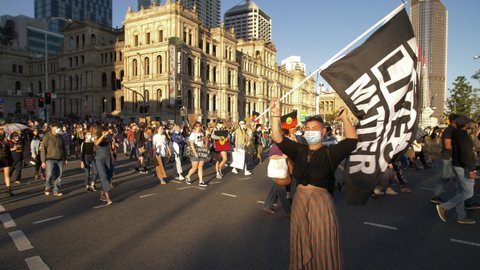 BRISBANE, QUEENSLAND, AUSTRALIA. JUNE 06 2020. Black Lives Matter flag held by protestor, slow motion.