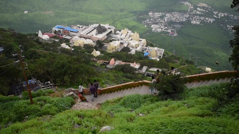 
View of Jain Temples in Junagadh with city from Girnar mountain in foggy morning. View from half way to the top of Girnar Hill. Gujarat, India