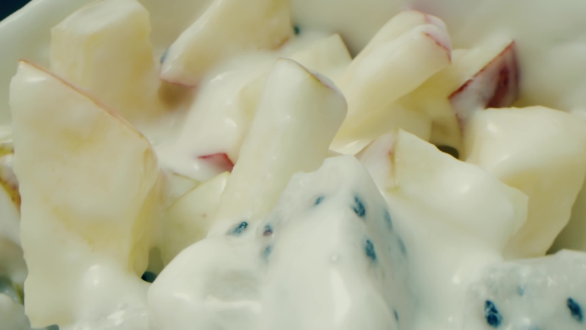 Yogurt with apple and pear sliced with dragon fruit and bananas in a glass. Close-up view of yogurt with fruit. Healthy breakfast or snacks, clean food concept
