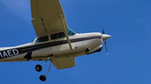 Ferrara Italy JUNE, 27, 2021 Private Cessna plane takes off from a countryside airfield in blue sunny sky and retracts the landing gear. Cessna 172RG Cutlass I-MAED.