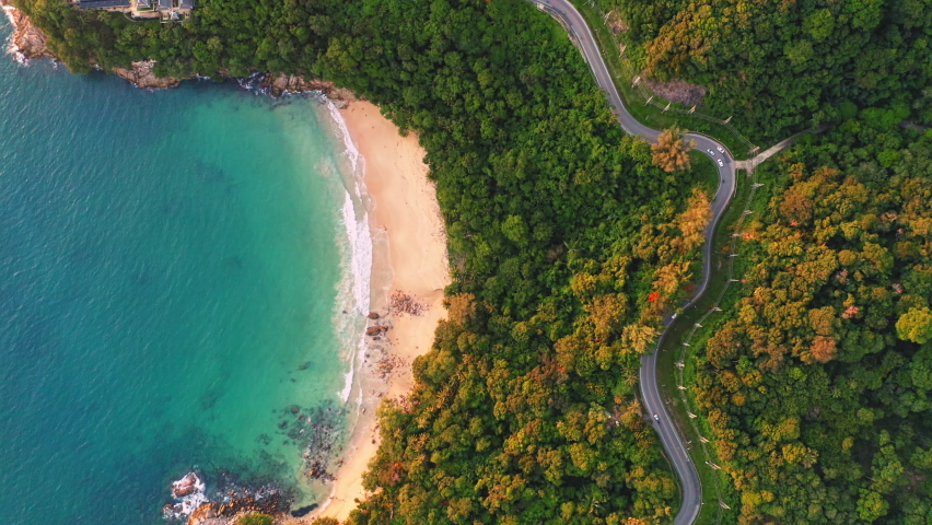 4K Areal drone top down view of curves of coastal road Phuket Thailand beautiful Top view seashore Drone shot over seashore Phuket is famous tourist destination. Top view traffic road around the beach | Shutterstock HD Video #1075709903