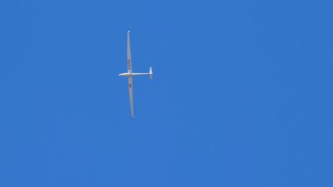 Ferrara Italy JUNE, 27, 2021 Glider soaring in the blue sky in a thermal ascent. Gliding is an extreme sport with the goal of travel the maximum distance without engine. DG Flugzeugbau DG-800 D-KTGE
