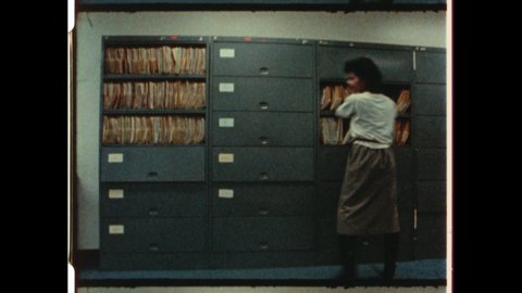 1980s Chicago, IL. Woman Quickly Searching Filing Cabinets. The fast paced animated sequence aallows woman to search multiple folders. 4K overscan of Vintage Archival Film Print