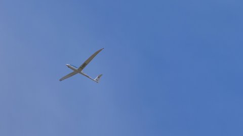 Ferrara Italy JUNE, 27, 2021 Sailplane flying in the blue sky with elongated and arch-shaped wings. Gliders fly without engine only by using natural forces like winds and thermals. Schempp-Hirth Arcus