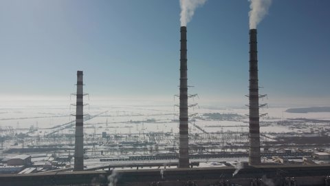 Chimneys of a thermal power plant. Shooting from the height of an energy object running on fossil fuels. Burshtyn Ukraine.