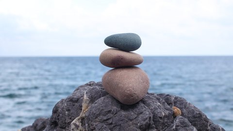 Rocks balancing on the big stone on the sea. Zen harmony meditation and relaxed concept