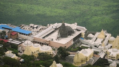 High angle view of Jain temples at Junagadh, Gujarat, India. Holy old pilgrimage of Hindu people. View of temple and city from Girnar mountain