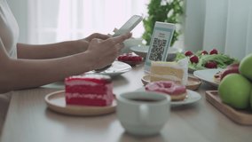 scan QR ode online concept. woman using the phone to scan the QR code to select the food order. Woman scan to receive discounts or pay for food and to use to transfer money online.  - Powered by Shutterstock - Get 15% off with code: PIKWIZARD15