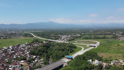Malang, East Java Indonesia - July 11 2021: Malang city toll road gate aerial view