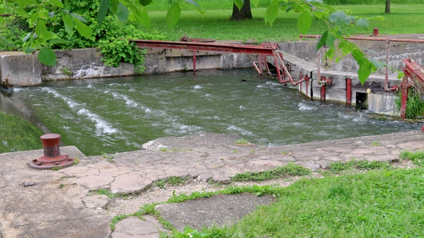 Pan of remnants of a lock and dam mechanisms on historic Hennipen Canal (aka Illinois Mississippi Canal); Hennipen Canal Trail State Park on lovely summer afternoon