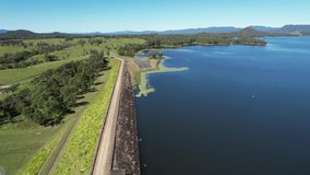 Drone aerial over Teemburra Dam wall towards car park and boat ramp, showing water and landscape