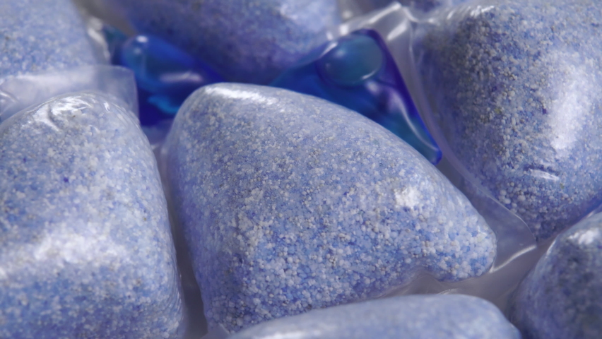 Combined dishwashing pods with powder and blue gel. Macro shot. Rotation | Shutterstock HD Video #1075732166
