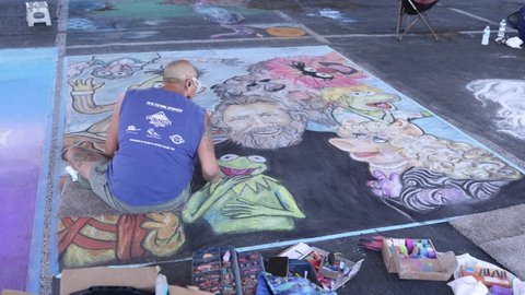 Reno, NV - USA - July 11 2021: A Chalk Artist Working on his Piece at the Reno Chalk Art Festival - Shallow Depth of Field