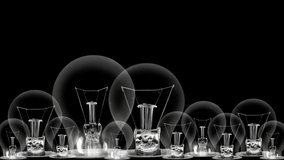Group of light bulbs in a row going from dark to light with Story Telling, Marketing, Content, Creativity and Share fiber text on black background. High quality 4k video.