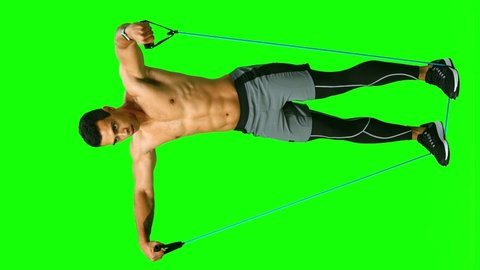 Man with athletic body performs exercises using expander. Full length. See other exercises. Vertical footage