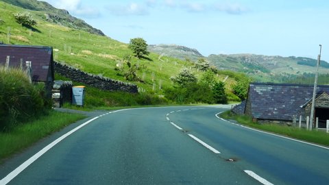 Car point of view, POV driving A4086 road in stunning rural scenery of Snowdonia on a nice summer day.