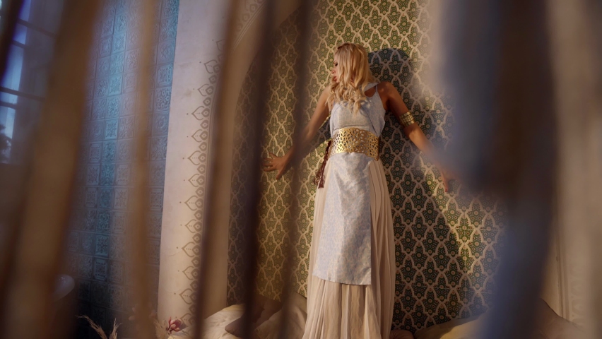 blonde woman is dancing alone in oriental palace, fantasy and fairytale shot