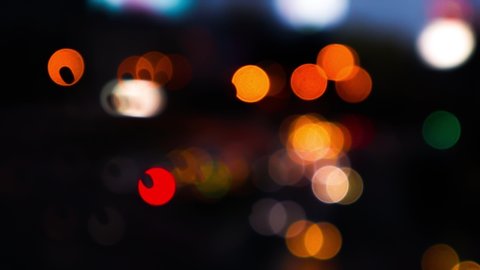 Night road lights blurred bokeh of cars in traffic on the road at night. Abstract bright blurred colored bokeh. Bokeh lights in the city night background