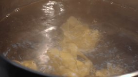chef throws fettuccine into boiling water