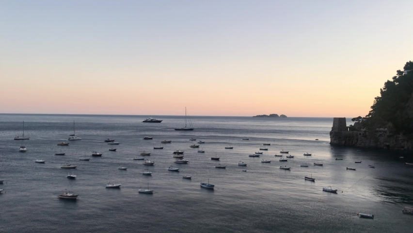 calming and relaxing landscape, sunset colors on the sea with boats