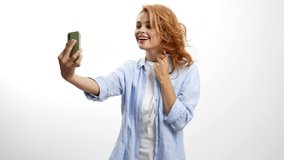 cheerful woman blow kiss on smartphone camera posing for photo, selfie