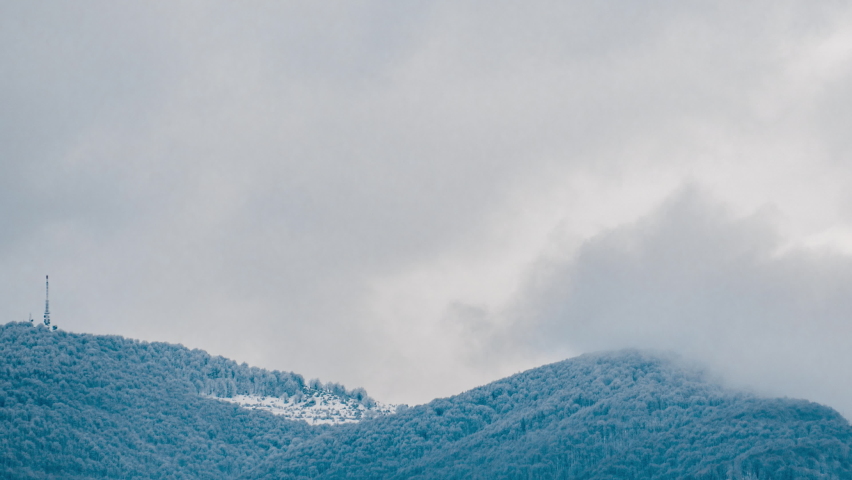 Time lapse of storm clouds moving over mountain peaks