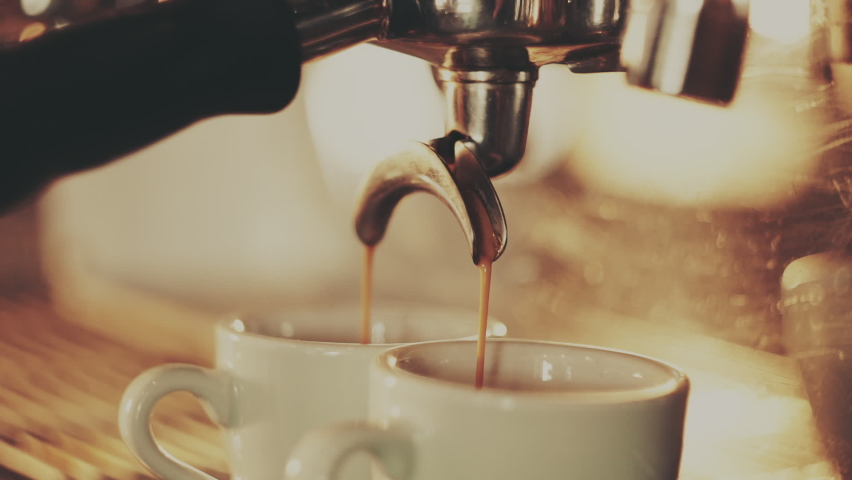 Barista making two espresso in a coffee machine | Shutterstock HD Video #1075764452