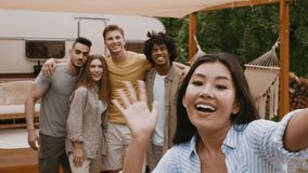 Group Of Multiracial Friends Making Video Call While Having Fun In Camping, Cheerful Men And Women Posing Near Camper Van, Waving At Camera And Inviting Friends To Party, Webcam Pov, Slow Motion