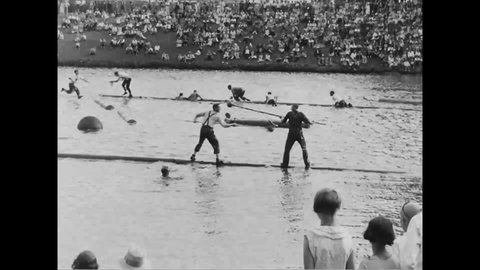 CIRCA 1930 - Men compete in log rolling and other logger sports on the water in Longview, Washington.