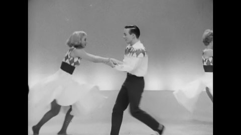 CIRCA 1956 - Couples complete a dance in a review with twirling and cartwheels.