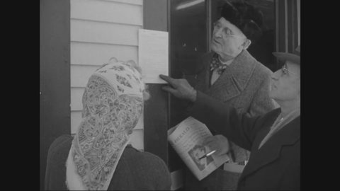CIRCA 1950 - Parents in the wintry town of Pittsford, Vermont speak to others in the community to vote for a higher school budget.
