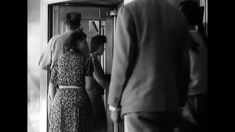 CIRCA 1940s - Visitors of all ages use a revolving door to enter an exhibit on aviation at New York's Museum of Modern Art.