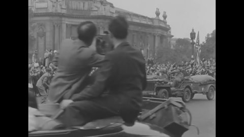 CIRCA 1944 - An allied military parade marches and drives artillery through the streets of liberated Paris.