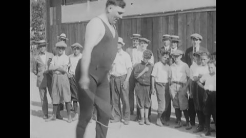 CIRCA 1929 - Children watch a heavyweight boxer jump rope, and an announcer introduces Jimmy McLarnin.